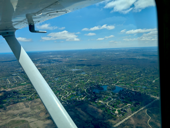 Looking towards the Chicago Skyline from the North West in the air. Suburbs below (and some absolutely massive houses)