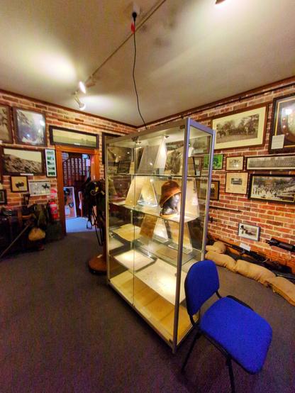 Inside the museum. I think this room is the World War I exhibit? Old photos line the brick walls, a glass display cabinet sits in the middle of the room.