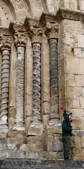 little kid dressed as a soldier with a carnation, in front of a Portuguese church
