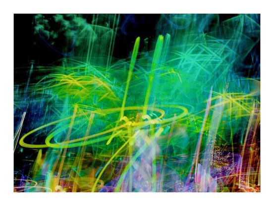 Das Bild ist eine Fotografie, die mit ICM-Technik und Mehrfachbelichtung entstanden ist. Im Vordergrund ist eine Palme aus LEDs in überwiegend grüner, aber auch gelber Farbe zu sehen. Im Hintergrund finden sich Spuren vieler anderer LEDs in verschiedenen Farben.
