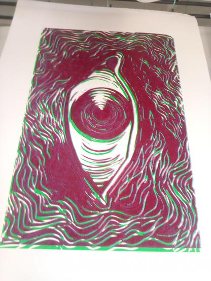 Page with print in mostly red of an eye surrounded by wavy lines, green and blue versions are printed offset under it