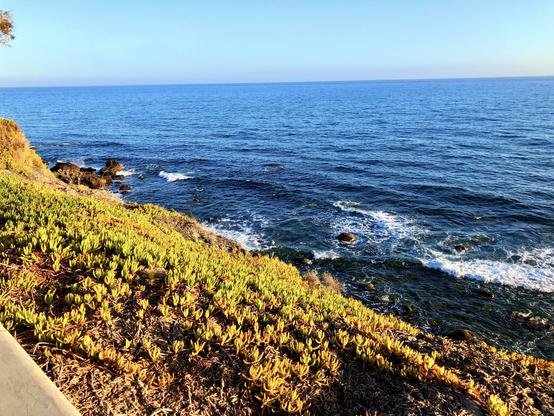 Gran Canaria, Meloneras at sunset. This is perhaps one of my favourite spots in the south of the island to watch the sun set while strolling along the coastline's boulevard, enjoying the intensity of the blue colours from both the sky and the ocean as they merge. The ocean waves hitting the rocks gently, all in all, a soothing event to end up the day with a high note