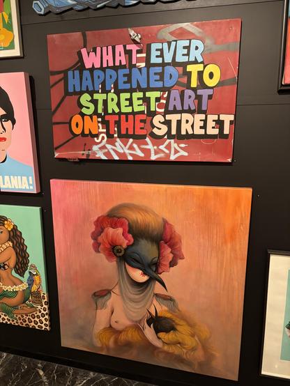 A pair of colourful paintings hanging on a wall.