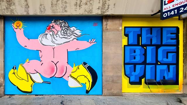 A mural featuring Billy Connolly, naked apart from his trademark Banana Boots, running down a Glasgow street.