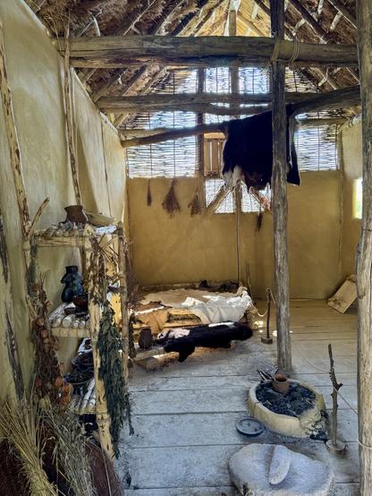 Interior showing imagined sleeping arrangements and various paraphernalia of everyday life.