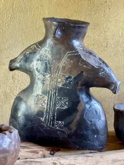 Decorated pottery vessel in shape of figurine (replica).