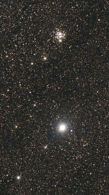 A big bright star sitting next to a tight little cluster of stars.