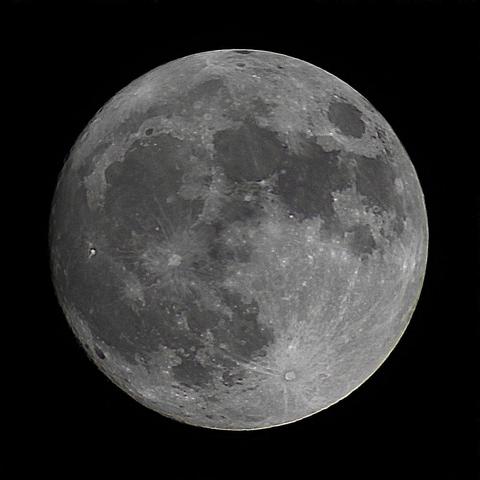 The Moon at nearly full on a dark sky background.