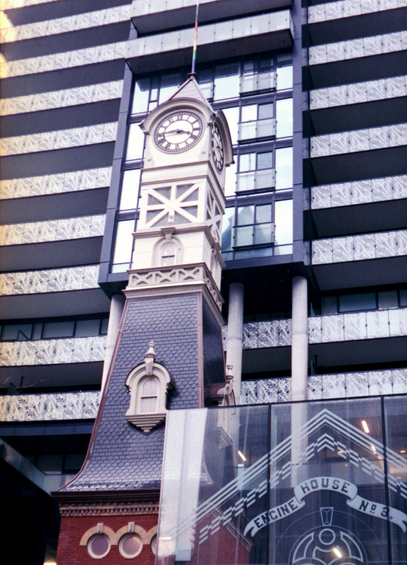 The remnants of the St. Charles Tavern clock tower is dwarfed by the condo tower into which it has been incorporated.