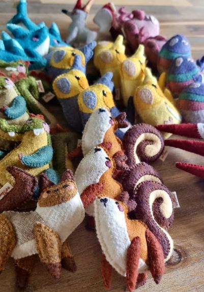 Picture of a bunch of handmade felt plushies representing various cute and colourful animals.
