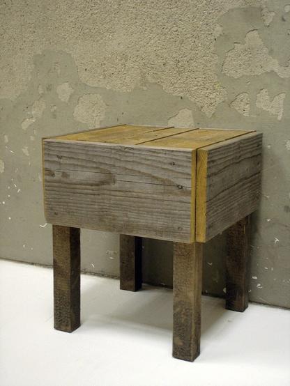 picture of a wooden stool made of found, weathered wood and nails.