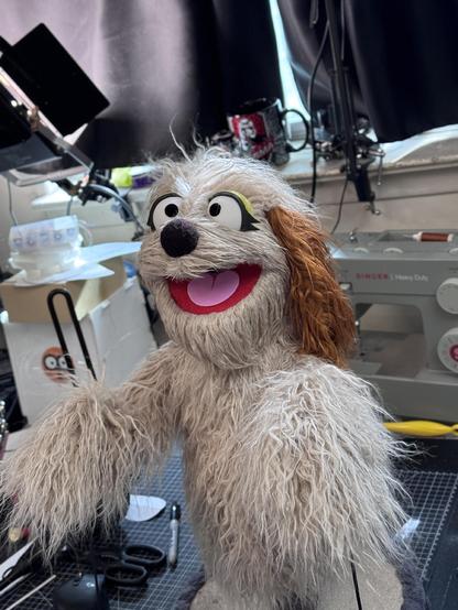 Beige dog hand puppet, left three quarter view
