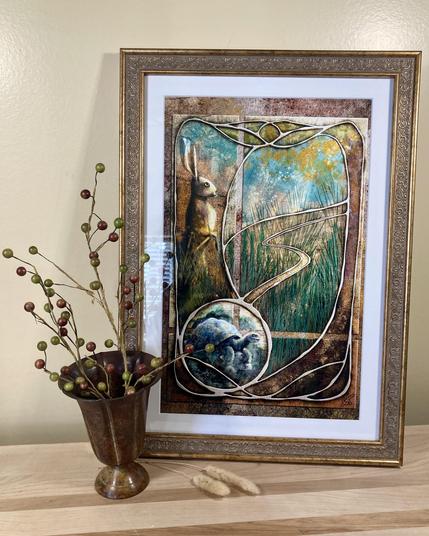 Photograph of an illustrated art print based on the Tortoise and the Hare, decoratively framed and posed with a vase of berries. Primary colors are buttercup yellow of the wall and wood of the stand.