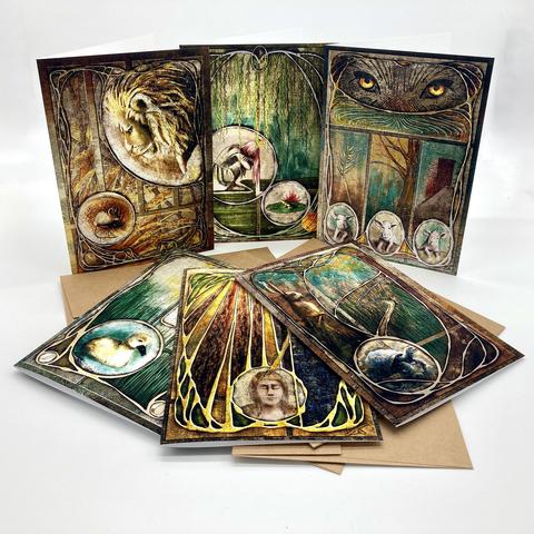 Product photo of six illustrated greeting cards inspired by fairy tales and fables, arranged on a white background with kraft paper envelopes.