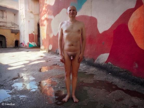 Me naked in the half-abandoned urban area in summer. Self-Portrait. Front view