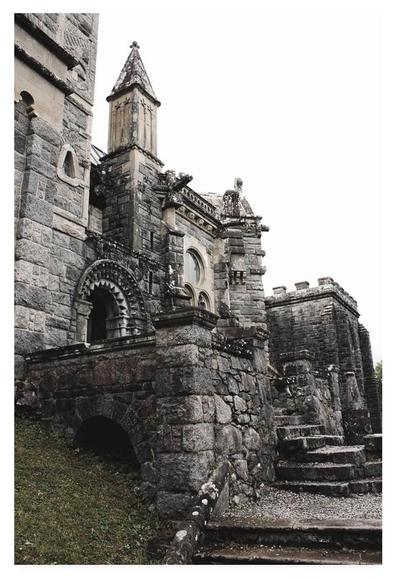 Colour portrait photograph of an ornately carved granite church.