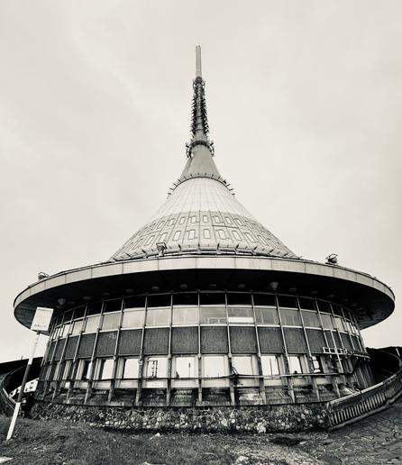 Ještěd Tower building, sharply pointed conical futuristic design building on mountaintop in Czechia.