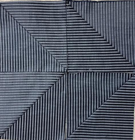 4 squares made of one striped fabric. Each square is made of two half square triangles with the stripes at 90 degrees. Put together there are now chevrons with one side with the stripes vertical and other side horizontal