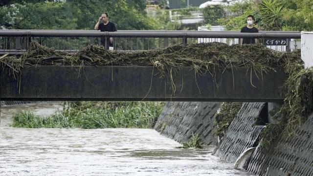 Slow tropical storm dumps heavy rain around Tokyo after causing floods in southern Japan