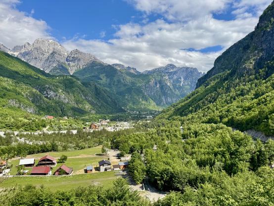 Village occupying flat land in a valley between mountains