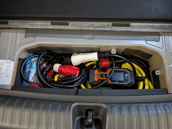 A photo for the charger packed in the compartment under the bottom of the trunk.
