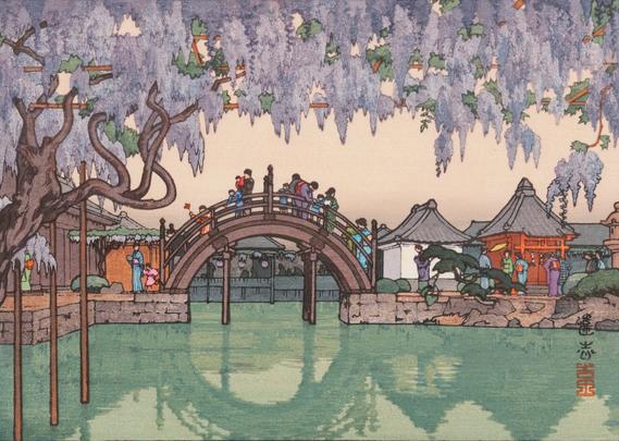 In the foreground, a wisteria tree in bloom stretches across a pond, its branches heavy with purple flowers, their weight supported from below by wooden poles. Beyond, pedestrians cross a short bridge with an exaggerated curve; combined with its reflection in the still water of the pond, the bridge is designed to create a complete circle.