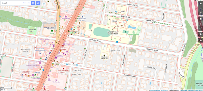OpenStreetMap data rendered with the TracesTrack Topo style. A lot more is visible than on Google Maps, including: footpaths, many shops, amenities like the local Library, cop shop, church, playgrounds, childcare centre, vegetated areas, trees, bike racks, ATMs...
