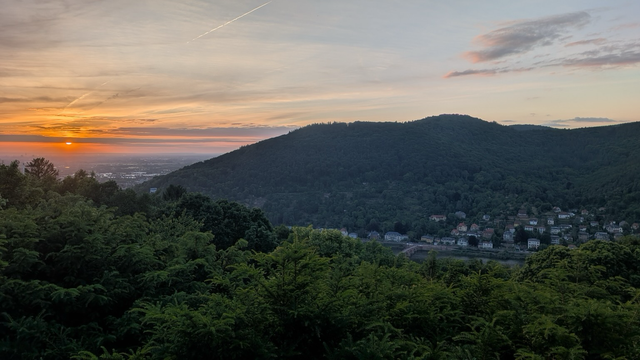 Sun sets on the plain at the end of the valley hosting Heidelberg