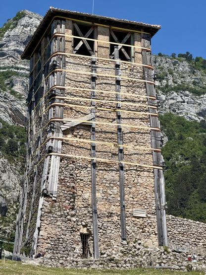 Stone tower supported by blocks of wood & steel cables