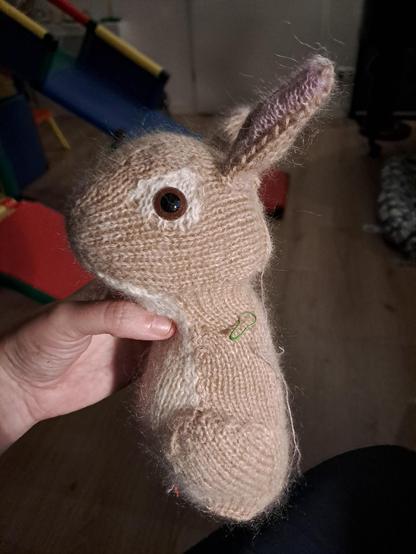Peter Rabbit body finished and its ears and eyes. Light brown. Knitted.