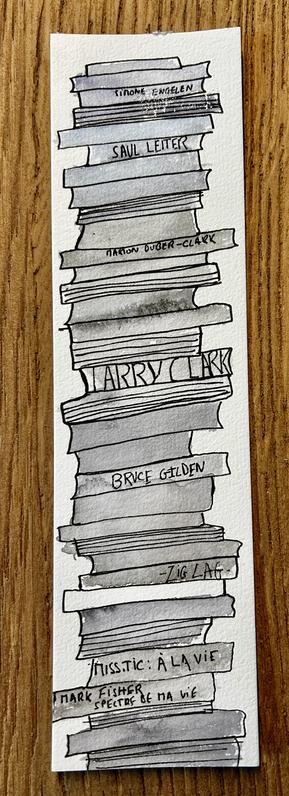 a stack of book with water color on a bookmark pad