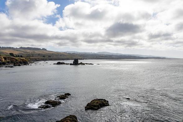 A view of the beautiful California Pacific Coast at Pigeon Point Light Station, showcasing rugged landscapes and tranquil ocean views.