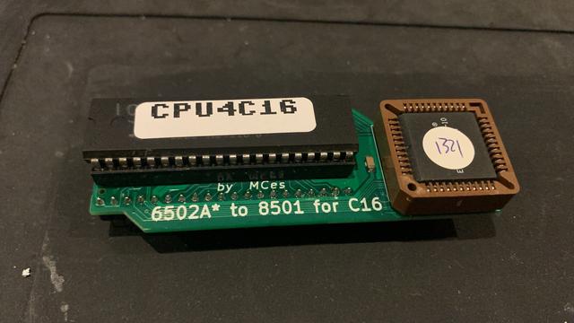 A small green PCB with a square PLCC chip and a DIP40 chip, the latter being the 6502 CPU.