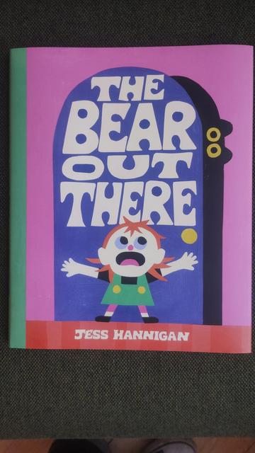 Front dustjacket cover for The Bear Out There by Jess Hannigan, with a little girl trying to hold a front door closed as a dark figure tries to push in