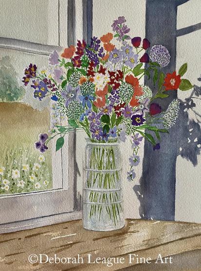 Flowers in glass vase on window sill. A floral bouquet bursting with colorful blooms in a glass vase sits on a well worn wooden window sill. Outside in the distance, the landscape includes trees, bushes and grass. Nearby, white flowers growing by the house can be seen through the large paned window. Sunlight streaming into the room creates an interesting shadow on the far right wall in the painting. Pretty, country-feel, vertical still life.
