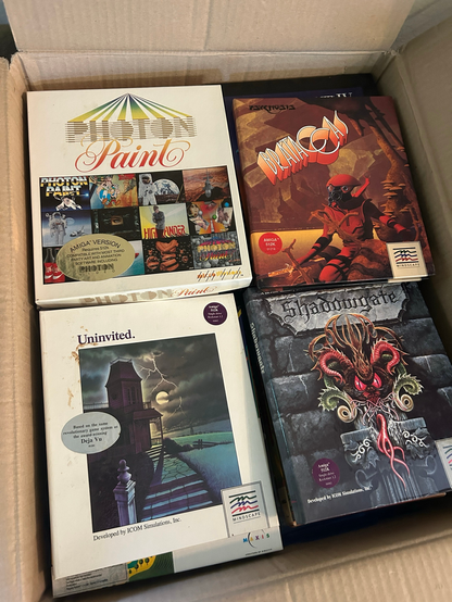 A large box of CIB Amiga games like Photon Paint, Shadowgate and Univited
