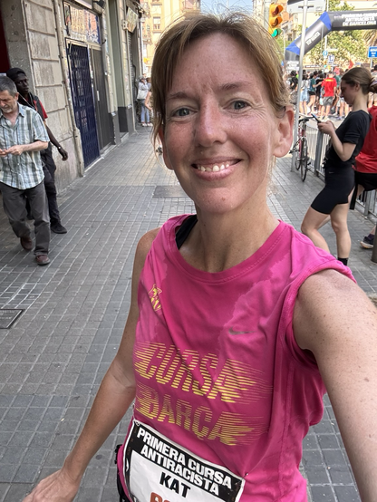 Sweaty selfie of a woman smiling after running a 5K in high humidity