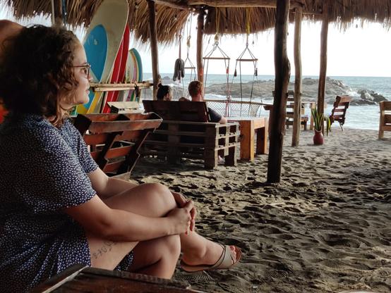 Ivonne looking out over the ocean at sunset from the Simple Beach Lodge