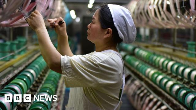 Woman working at a silk weaving factory in Fuyang in central China's Anhui province. Woman working at a silk weaving factory in Fuyang in central China's Anhui province.