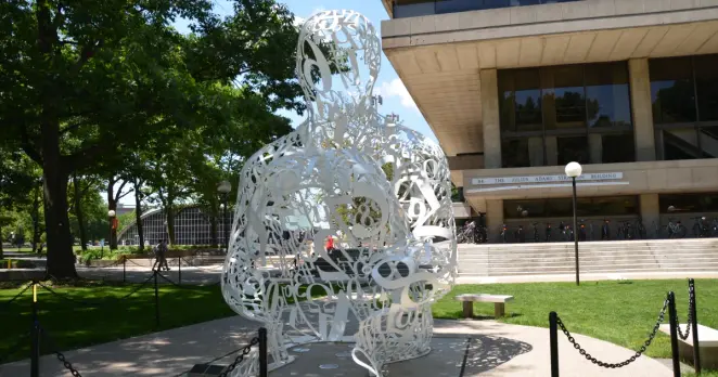 Sculpture made of tainless steel, white enamel paint featuring collages of letters, numbers, or symbols that appear to be in the process of organization.
