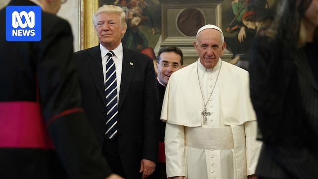 The two men standing shoulder to shoulder, Pope Francis does not look amused 