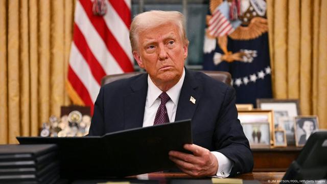President Donald Trump signs an executive order 