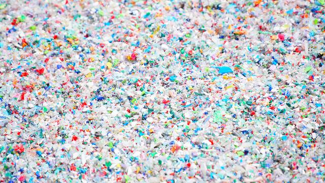 Colorful bits of plastic are spread across the image.