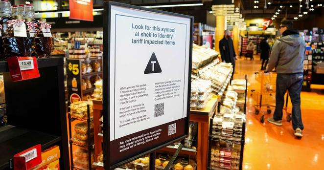 A sign advising that products from the U.S. affected by a tariff will be marked with a symbol at the shelf, with a QR code linking to a government of Canada website, is seen in a grocery store in Ottawa, on Wednesday, April 2, 2025. THE CANADIAN PRESS/Justin Tang