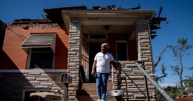 Dolly Baskin assess damage down Penrose Street while standing in front of her north St. Louis home on Saturday. Storms and a tornado swept through a large part of the city’s center the prior day, damaging hundreds of homes and leaving at least 5 dead.
