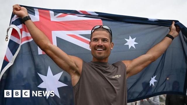 British ultra endurance runner William Goodge celebrates, holding an Australian flag, after crossing the finish line at Bondi Beach British ultra endurance runner William Goodge celebrates, holding an Australian flag, after crossing the finish line at Bondi Beach