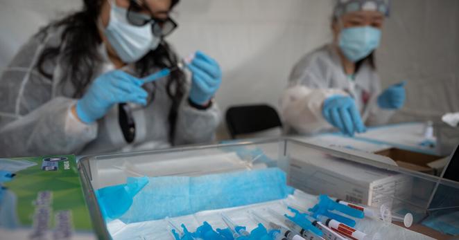 Preparing Covid vaccine doses at an outdoor mobile vaccination site in San Francisco in 2021.