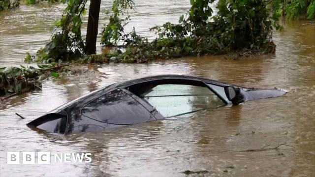 Black vehicle immersed in floodwater