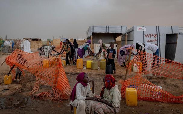 <p>Sudanese refugees at a water distribution point in Adre refugee camp, home to more than 150,000 people who have fled the war in Sudan. Photo by Ivor Prickett/Panos Pictures</p>