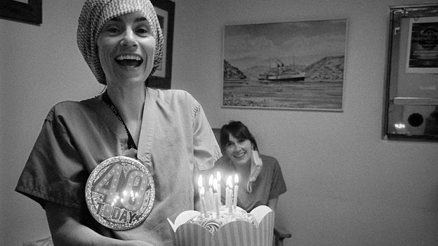 Woman holding birthday cake in black-and-white (Credit: David Collyer)